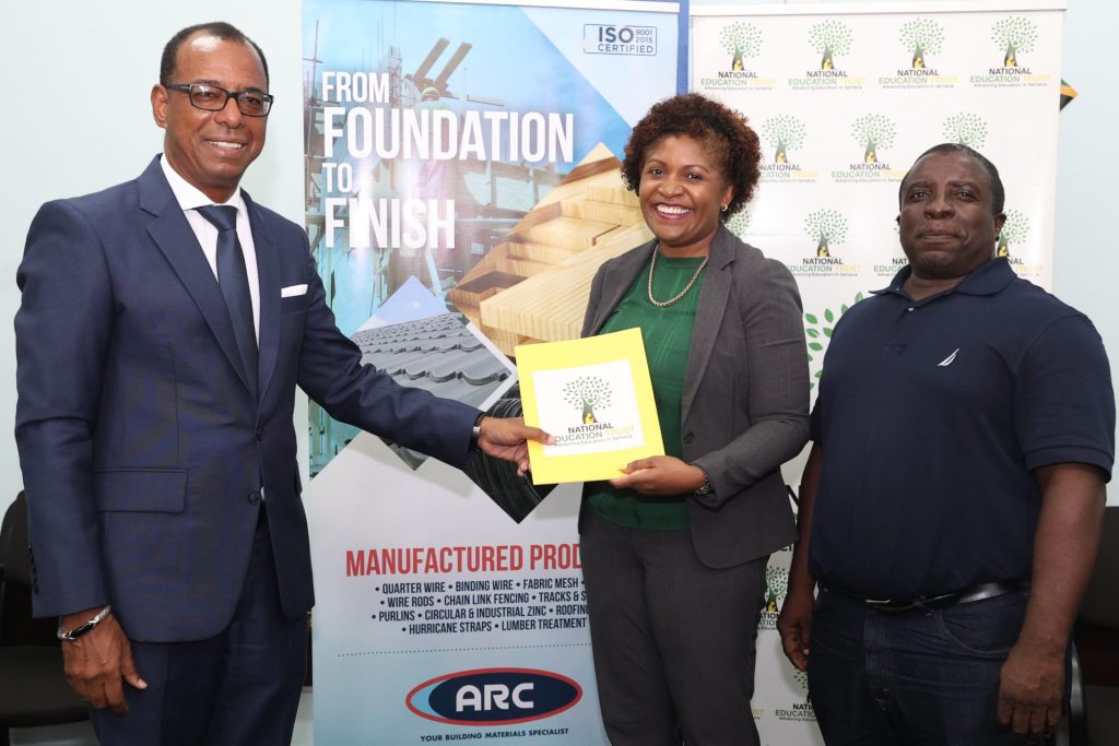 Latoya Harris-Ghartey (centre), Executive Director of the National Education Trust (NET), accepts the signed Letter of Intent from Norman Horne (left), Executive Chairman of ARC Manufacturing Limited, for the restoration of Bull Savannah Primary and Infant School. Also pictured is Colin Cameron (right), Principal of Bull Savannah Primary and Infant School. The signing of the Letter of Intent took place on Monday, August 5, at the NET’s office, located at the Caenwood Centre on Arnold Road, Kingston, in which ARC committed $12.5 Million to fund the restoration of the school’s roofing of the administrative block, canteen block and the Grades 1, 2, 5 and 6 blocks. 